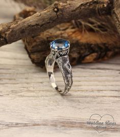 "A stunning vintage sterling silver engagement ring for the beautiful bride. An engraved branch with the texture of a real tree is adorned with twisted patterns and a large blue as clear sky topaz that plays with all its facets. A gift to make a special day magical. DETAILS: Stone - 9mm Natural Swiss Topaz Metal - recycled solid Sterling Silver Dimensions - width 9mm (0.35 in.), band width - 2mm (0.196 in.) Finish - oxidized (shiny at your request) View all silver branch rings:  https://etsy.me/3BrAI3m HOW TO ORDER ▪   Simply choose your ring size and a gemstone in dropdown menus. ▪   Add an engraving you'd like to have inside in the 'Personalization Box' (optionally). ▪   Feel free to contact me if you want to change anything about the ring design (dimensions, additional stones, material Branch Engagement Ring, Unusual Engagement Rings, Branch Ring, Silver Engagement Ring, Engagement Ring For Her, Real Tree, Wood Ring, Sterling Silver Engagement Rings, Local Jewelry