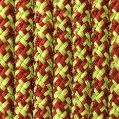 red and green braided fabric close up on a tablecloth or wallpaper pattern