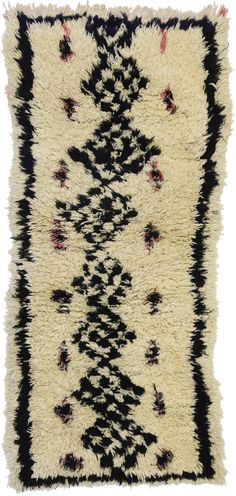 an area rug with black and white designs on it