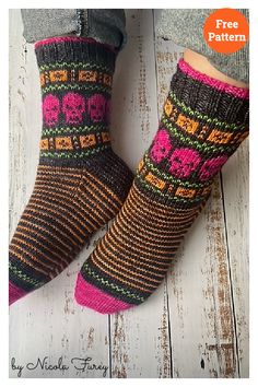 the legs and feet of a woman wearing socks with colorful knitted designs on them