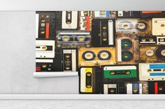 there is a wall mural made out of old cassette tapes