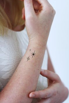 a woman with a small star tattoo on her arm