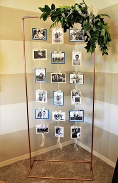 a metal frame with pictures and flowers on it in front of a wall decorated with photos