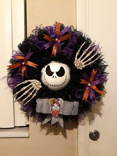 a skeleton wreath hanging on the front door