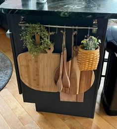 a kitchen island with cutting boards and utensils hanging from it's sides