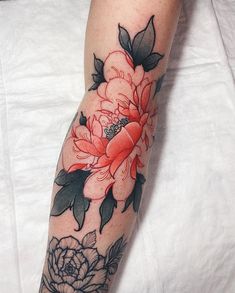 a woman's arm with flowers on it