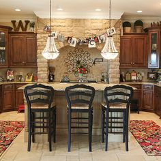 a large kitchen with wooden cabinets and an island in the middle is decorated for christmas