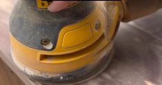 a close up of a person using a sander