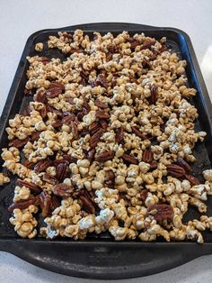 a tray filled with caramel popcorn on top of a table