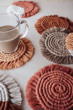 the coasters have been made with yarn and are next to a cup of coffee