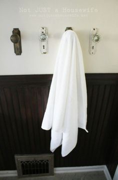 a white towel hanging on the wall in a bathroom