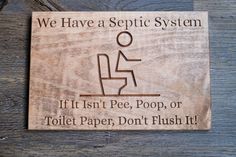 a wooden sign that says we have a sepic system if it isn't pee, poop, or toilet paper, don't flush it