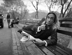 an old woman sitting on a park bench