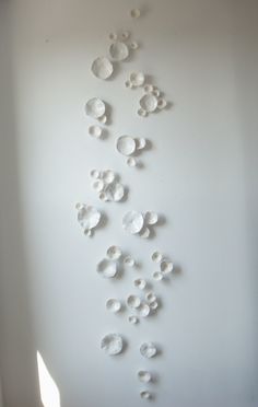 a white wall with many circles on it