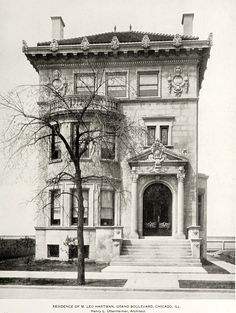 an old photo of a large building with stairs leading up to the front door and entrance