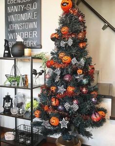 a decorated christmas tree with orange and black decorations