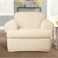 a white chair sitting in front of a clock