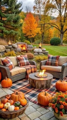 an outdoor fire pit surrounded by furniture and pumpkins