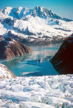 snow covered mountains and water in the distance