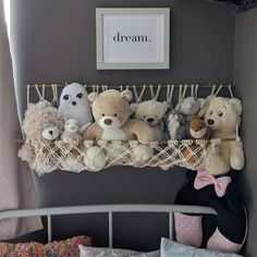 there are many stuffed animals on the shelf above the bed in this child's room