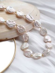 Experience the rebellious charm of our Elegant Rebellion Baroque Pearl Statement Necklace. This unique necklace breaks stereotypes with its refreshing twist on classic pearl jewelry. Versatile and sophisticated, it adds a touch of elegance to any outfit. With delicate golden accents and real-life texture, it's a perfect fashion statement that celebrates individuality and the unexpected. Metal: 18K Recycled Gold Plated On Brass Gemstone:Freshwater Baroque Pearl Pearl Dimensions:18mm Chain Length: 390mm+50mm extension chain Classic Pearl Jewelry, Pearl Statement Necklace, Tiger Eye Stone, Recycled Gold, Baroque Pearls, Unique Necklaces, Stone Necklace, Ring Bracelet, Chain Lengths