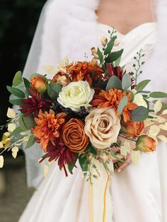 a bride holding a bouquet of flowers in her hands