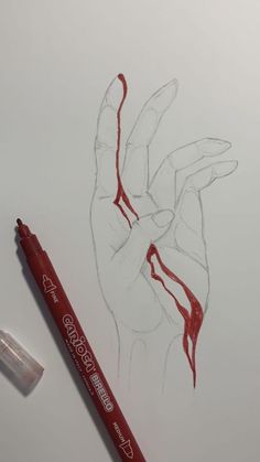 a red marker next to a drawing of a hand