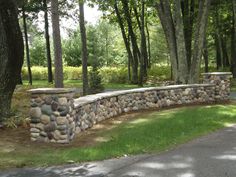 a stone wall in the middle of a park