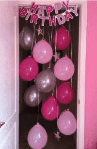 balloons and streamers are hanging from the door