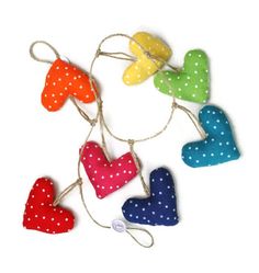 four hearts hanging from string with polka dots