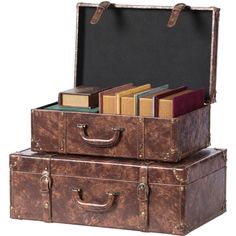 two suitcases with books in them sitting side by side on top of each other