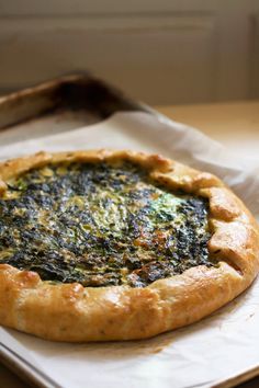 a spinach pie sitting on top of a white paper