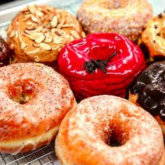 a bunch of doughnuts that are on a cooling rack