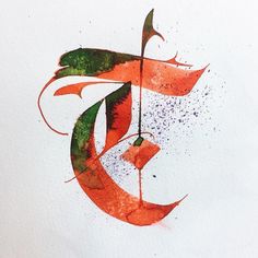 an arabic calligraphy type in red and green ink on white paper with watercolor splotters