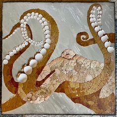 an octopus with pearls on it's head is depicted in this mosaic art piece