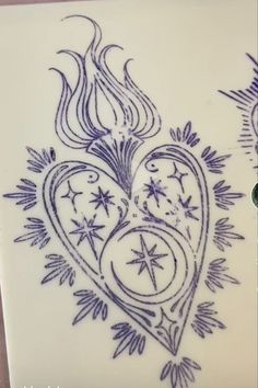 a drawing of a heart with stars and flames in the center on a white plate