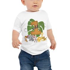 a baby wearing a white shirt with an elephant and giraffe design on it