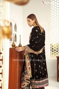 Pretty Pakistani Black Salwar Kameez Velvet Online emblazoned with Sequins, gota, sheesha work on velvet long kameez, Embroidery on neckline, sleeves along with raw silk trouser a pure traditional combination of dress for wedding parties. Shirt: Beautiful traditional Pakistani dress is designed in sequins Embroidery in front and back, having Dori Embroidered Neckline, Gota Embroidered Bodice. Front, back & Sleeves are fully embellished with gota, sheesha work with hanging tassels on ghaira in go Black Salwar, Long Kameez, Black Salwar Kameez, Velvet Dupatta, Hanging Tassels, Velvet Shawl, Raw Silk Fabric, Embroidered Bodice, Pakistani Dress