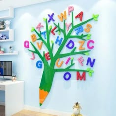 a child's room decorated with colorful letters and a tree made out of crayons