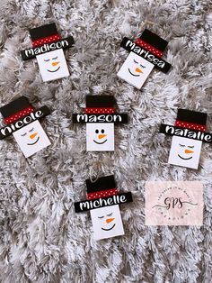 snowman name tags on a white carpet