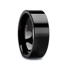 a black wedding band with an inlay design on the inside and outside, is shown