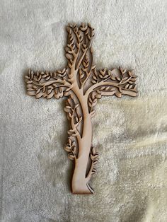 a wooden cross with a tree on it