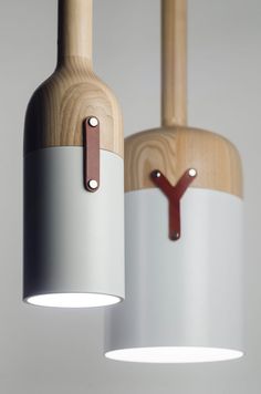 two wooden and white lamps hanging from the ceiling