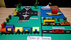 a cake made to look like a train track with cars and trucks on it that says mens of transport