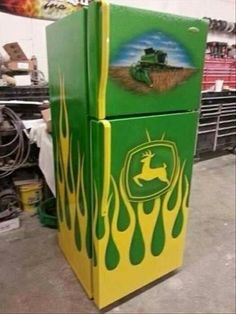 a green and yellow refrigerator sitting inside of a store