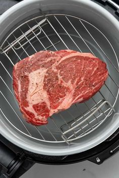 a piece of meat is cooking in an air fryer