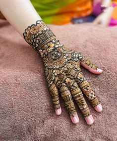 a woman's hand with hennap on top of her arm and fingers