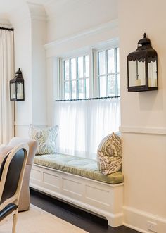 a dining room with a bench and windows