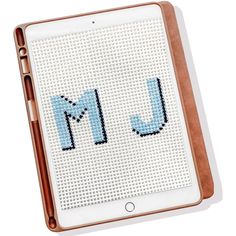 a cross stitch ipad case with the letter m on it's front and side