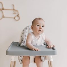 a baby is sitting in a high chair